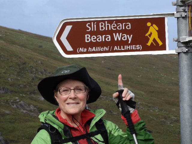 Woman pointing at the signal indicating Beara Way - National Waymarked Trails