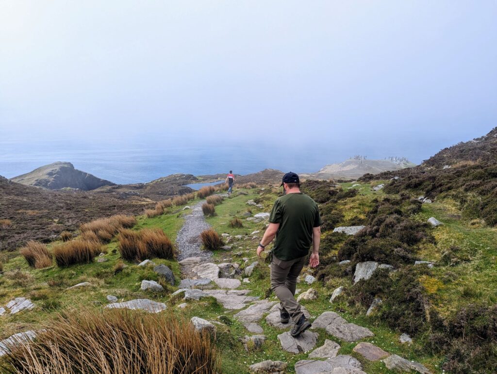 man hiking through mist on Slieve League Cliffs