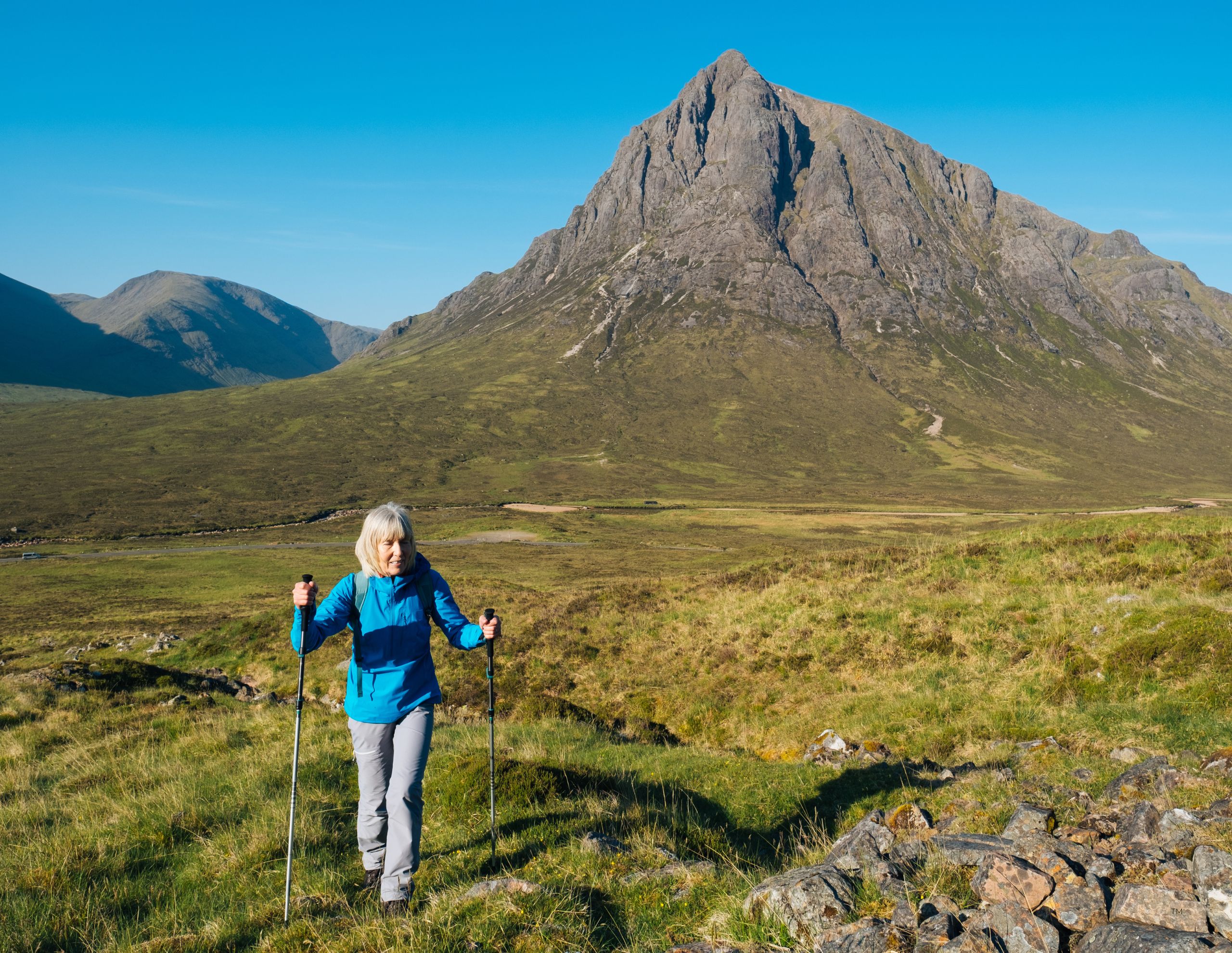 woman hiking mountains in Scotland