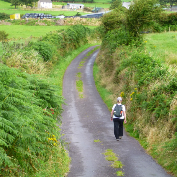 woman hiking country road in Ireland