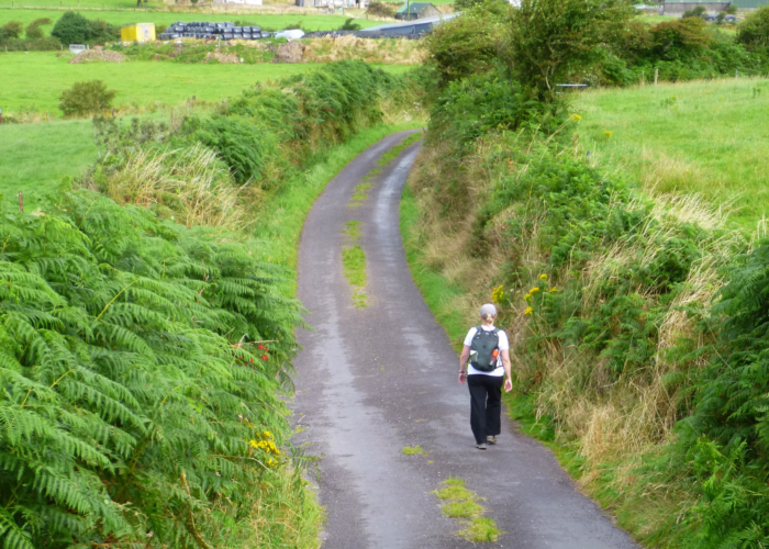 woman hiking country road in Ireland