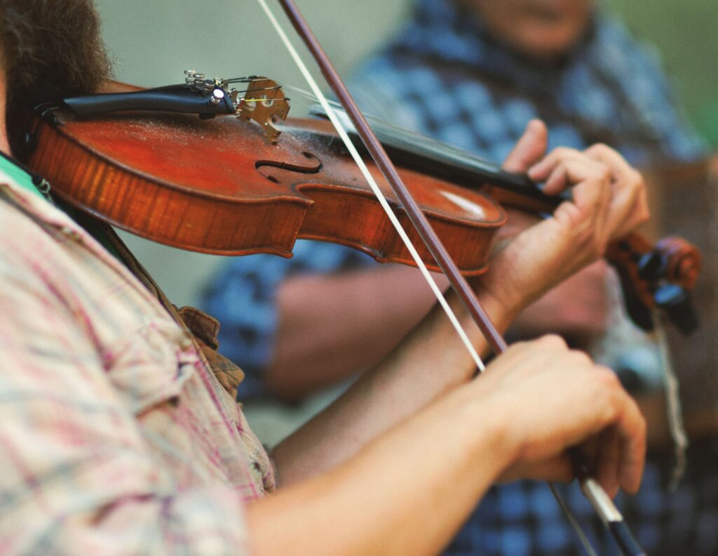 man playing fiddle at an Irish trad session