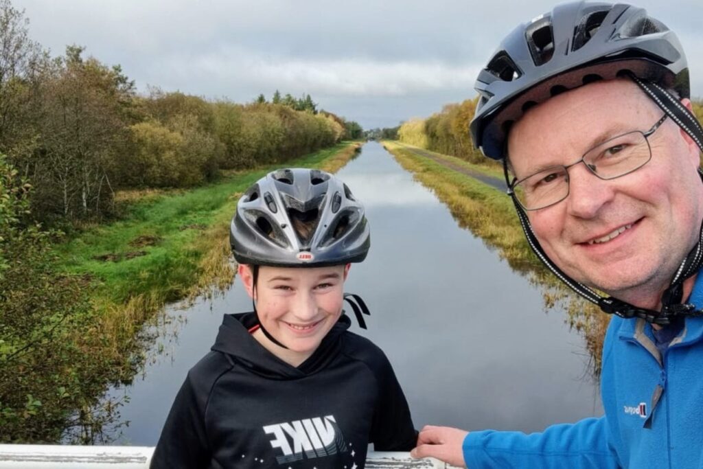 father and son with bike helmets on National Famine Way